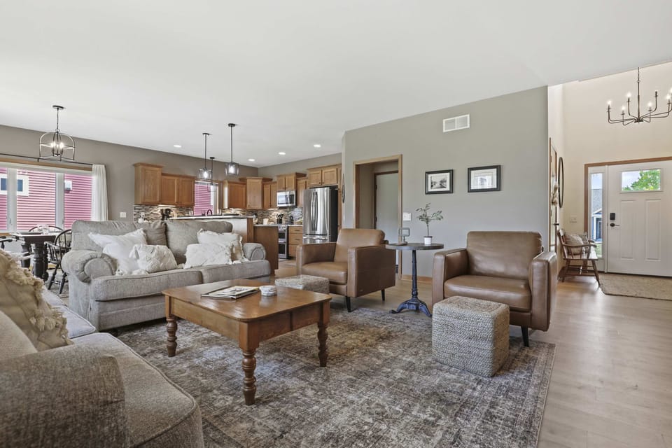 Main level living room with high end furniture, gas fire place, 50" smart TV, and an open living concept.