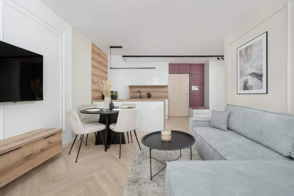 A modern living room with a comfortable sofa and soft natural light. Perfect for unwinding after a long day or entertaining guests.
