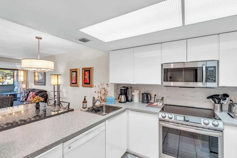 The kitchen has a full suite of stainless steel appliances in the kitchen