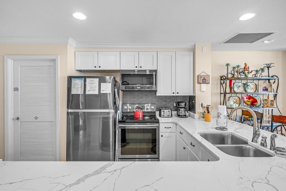 The fully equipped kitchen features quartz countertops, stainless-steel appliances, and everything you need to prepare meals for family and friends.