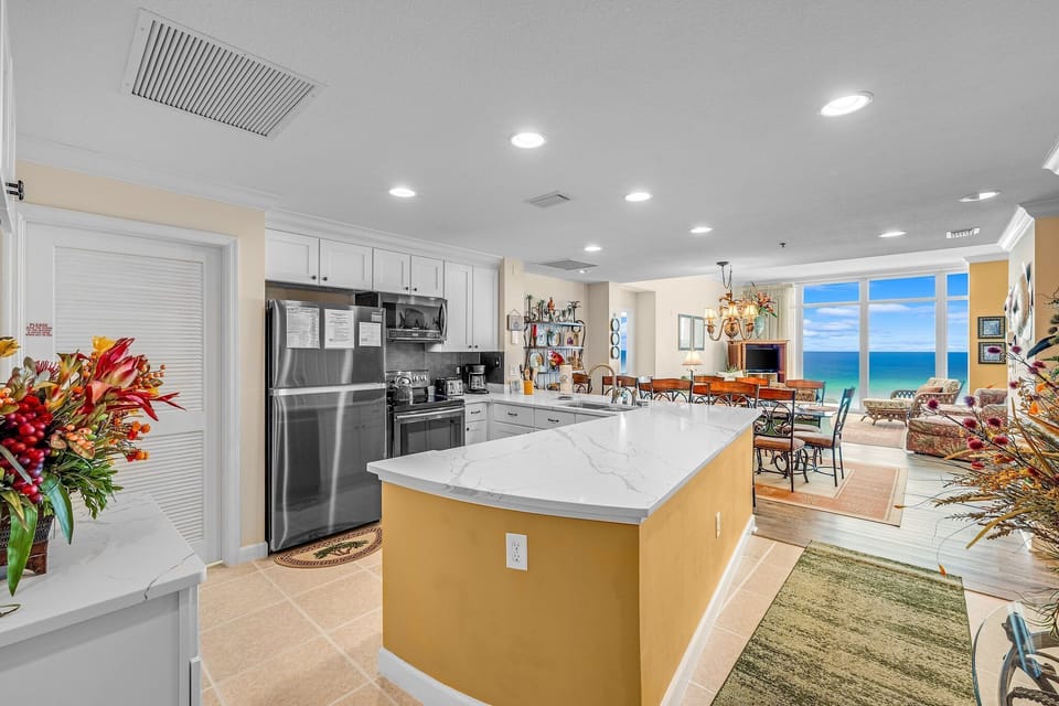 The fully equipped kitchen features quartz countertops, stainless-steel appliances, and everything you need to prepare meals for family and friends.
