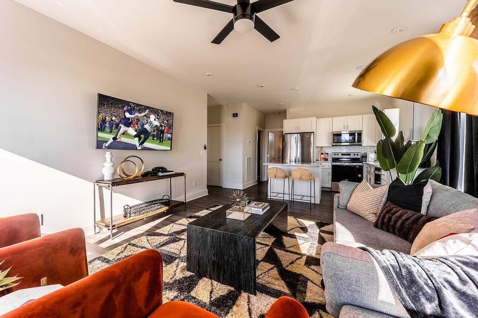 Open concept living area with comfortable seating and TV