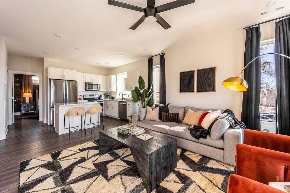 Open concept living area with comfortable seating and TV