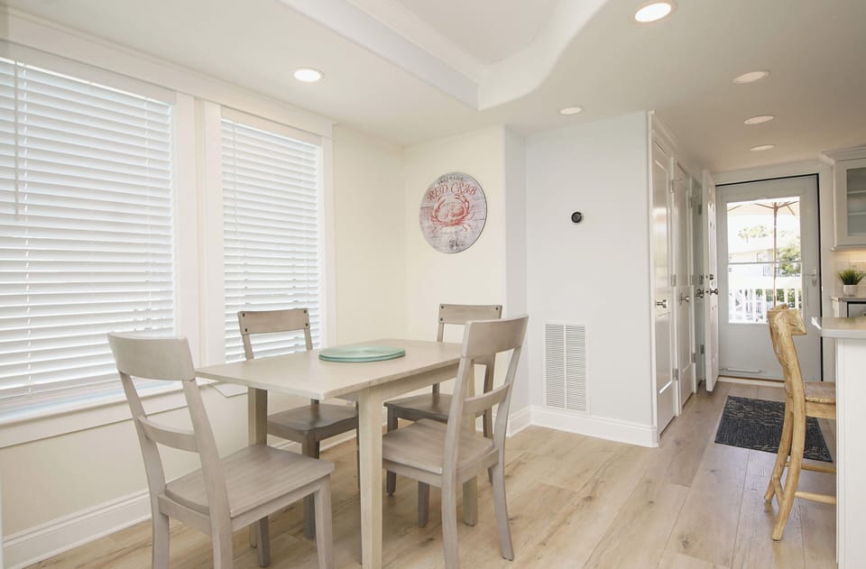 Gather around your bright dining table for memorable meals, with coastal charm and natural light streaming through.