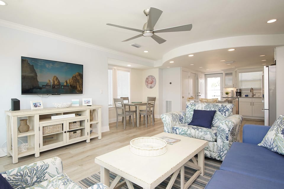 Your bright coastal haven flows seamlessly from living room to kitchen, with ocean-inspired décor and modern comforts perfect for relaxing.