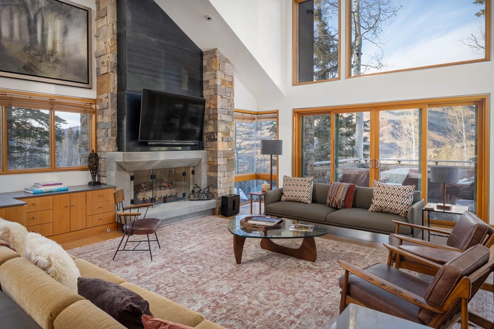 Living Room - Modern mountain mine-shaft design flooded with natural light from the large windows with beautiful mountain views