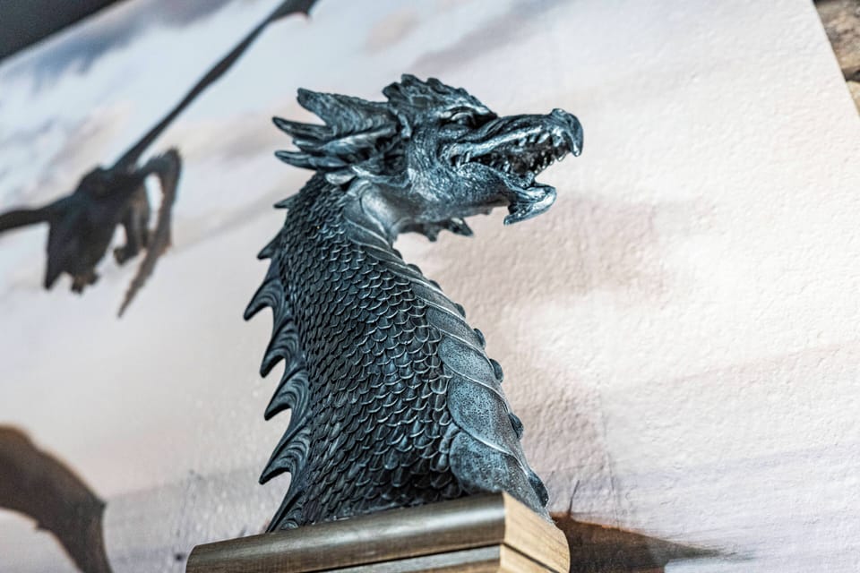 A stunning dragon sculpture captures attention with its intricate details, adding a mythical charm to the decor. The subtle background hues enhance its bold presence, creating a memorable focal point for your stay.