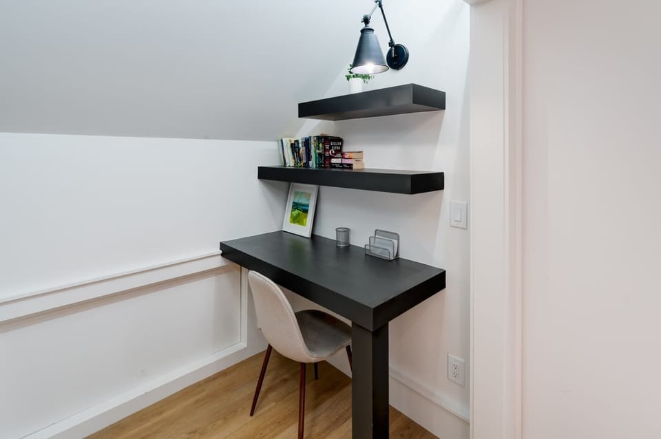 The primary bedroom offers a regal queen-sized bed & desk workspace
