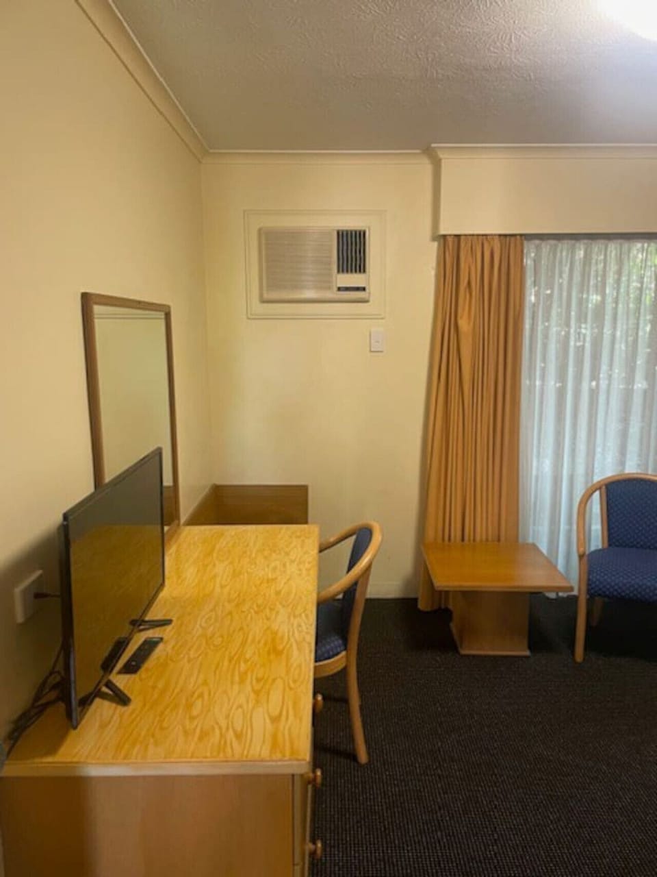 This room has a desk, spot to sit your luggage and Tv.
