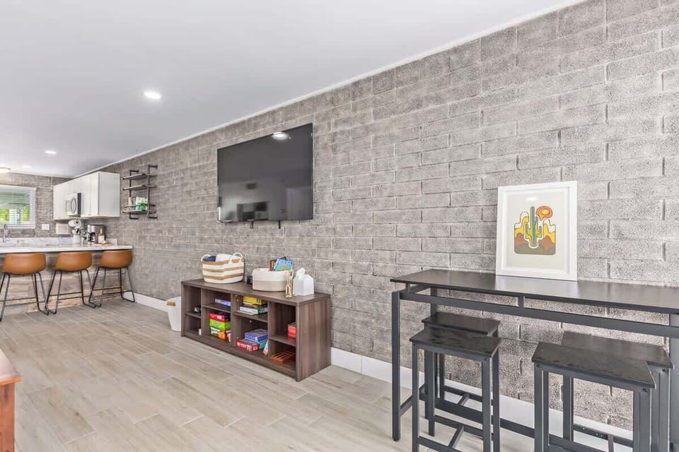 The living room features a large Queen sofa bed, a smaller Twin sofa bed, and a Smart TV for your entertainment.