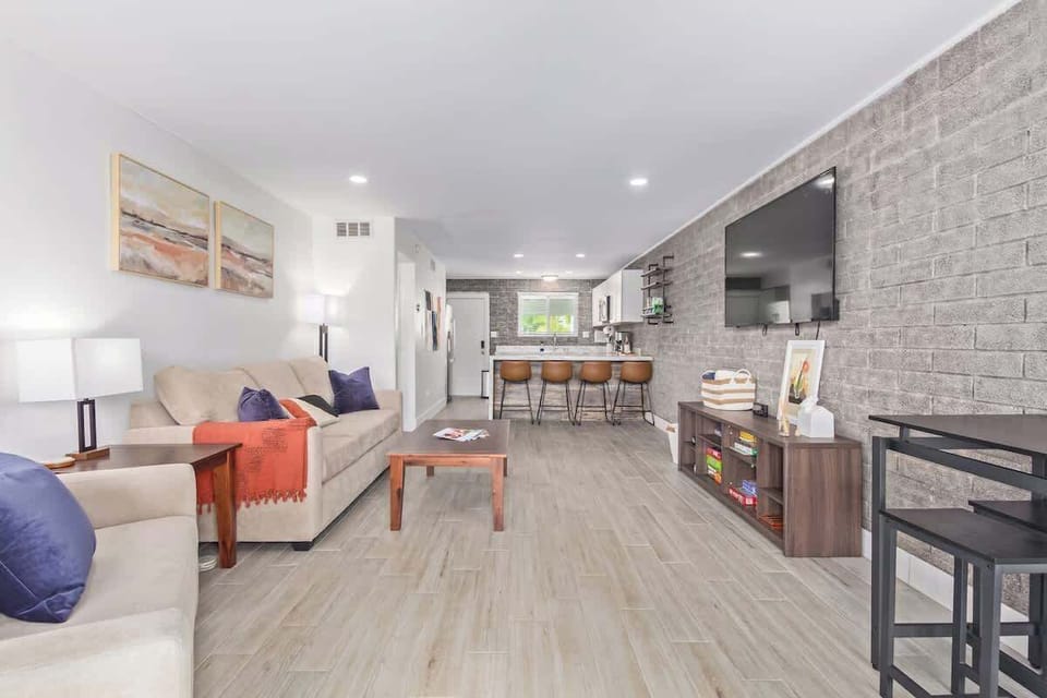 The living room features a large Queen sofa bed, a smaller Twin sofa bed, and a Smart TV for your entertainment.
