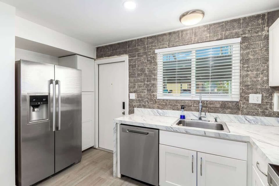 Full kitchen includes all the essentials and is complemented by a cozy dining area.