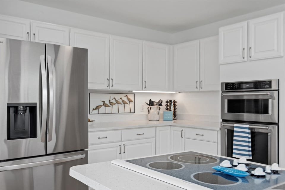 The seamless transition between the living room and kitchen ensures that entertaining becomes effortlessly enjoyable.
