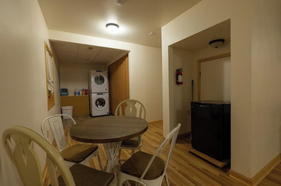 Lower level, full size stacking washer/dryer set. Seating area.