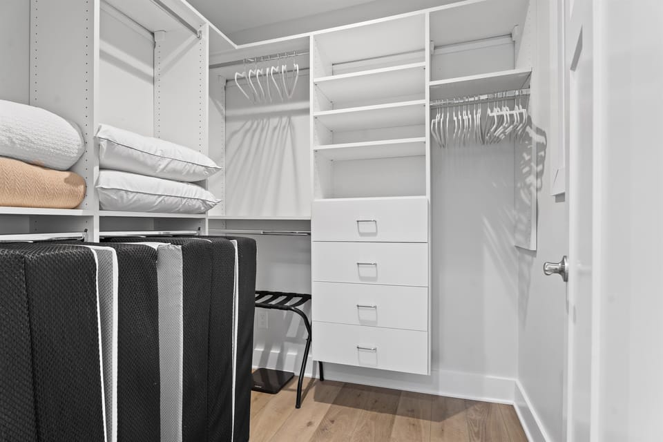 Large master closet with extra twin fold out mattresses and bedding.