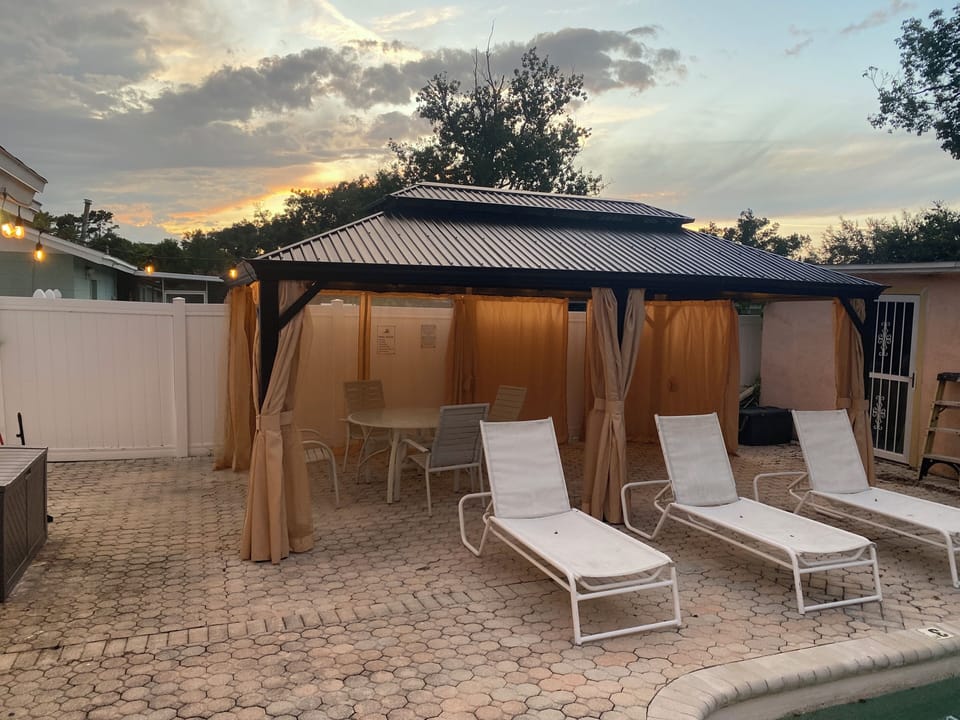 Gazebo with mosquito netting and curtains.