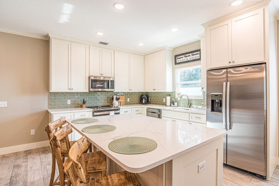 Fully stocked kitchen and breakfast bar for eating in.