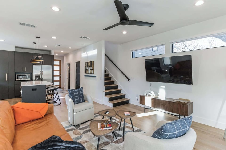 Contemporary living space with abundant seating and a Smart TV