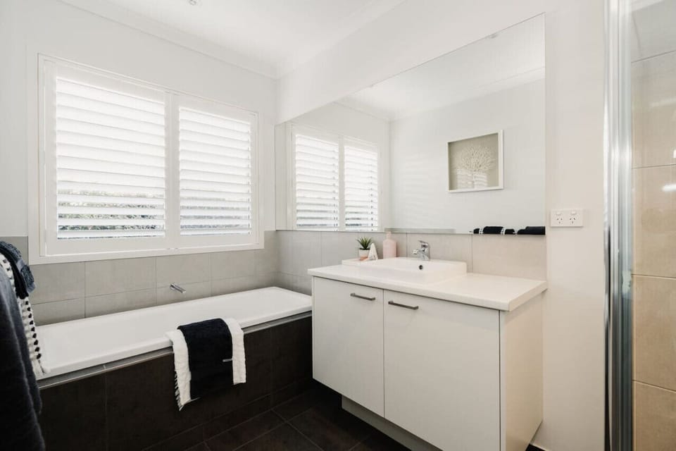 Main bathroom with shower, bathtub, and separate toilet