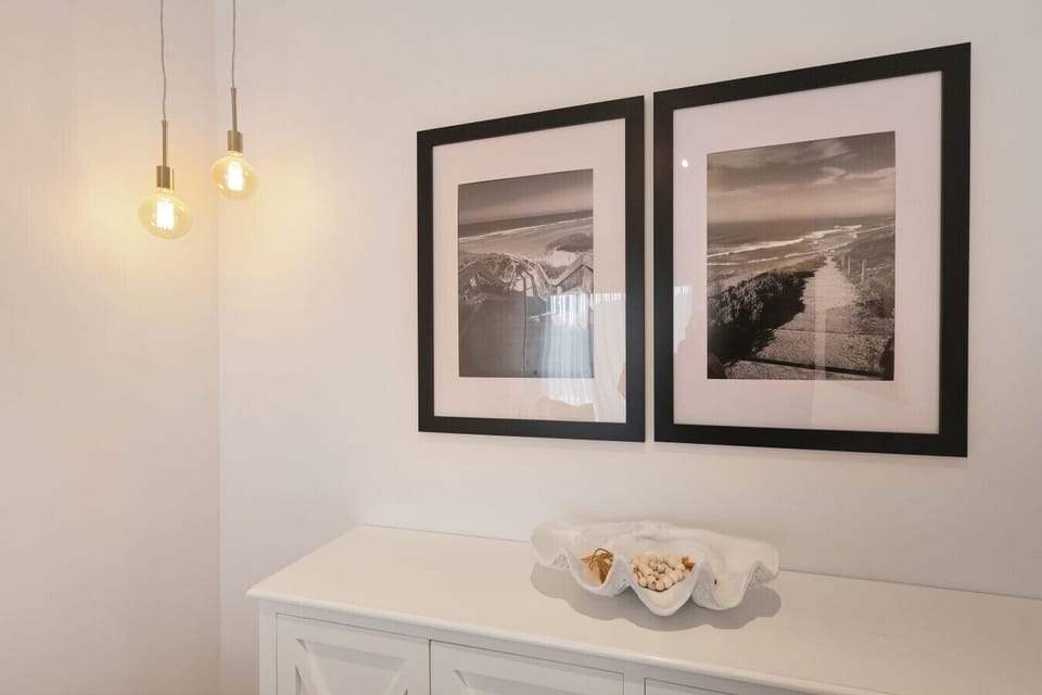 Stylish console table with ambient lighting and wall art