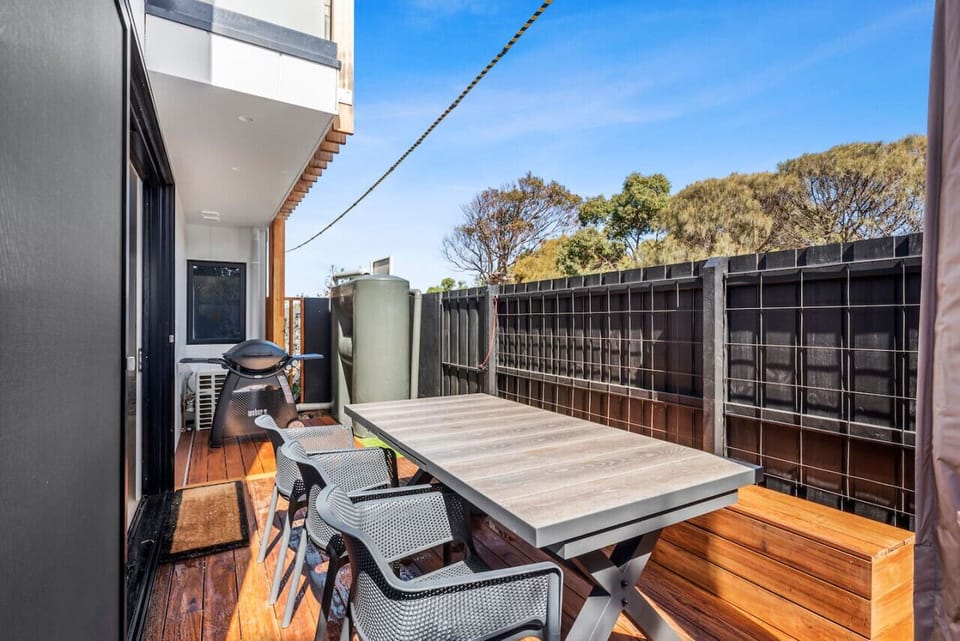 Large outdoor dining table, umbrella for shade and webber BBQ make for the perfect outdoor entertaining space!