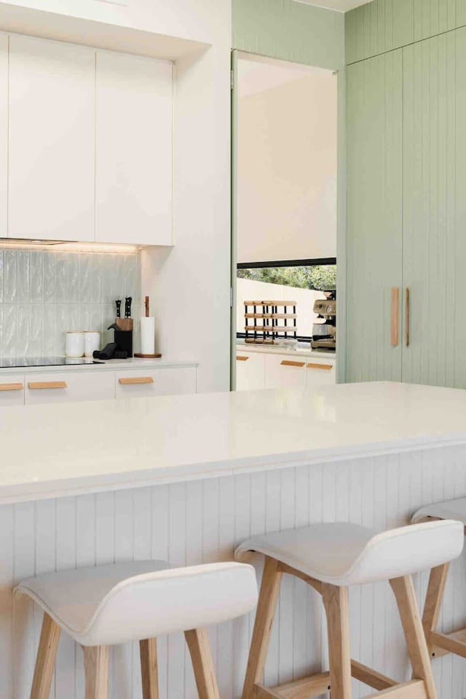 Open-plan kitchen featuring a generous island, clean lines, and natural light