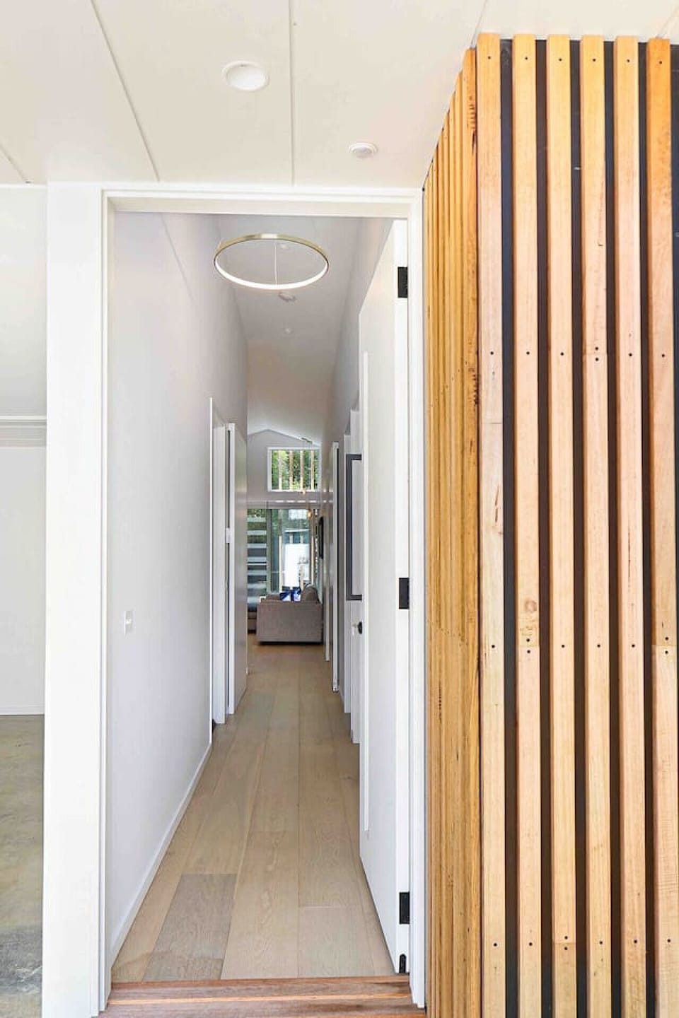 Clean and minimalist hallway connecting living and bedrooms