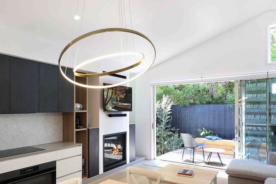 Modern living space with fireplace and access to private patio