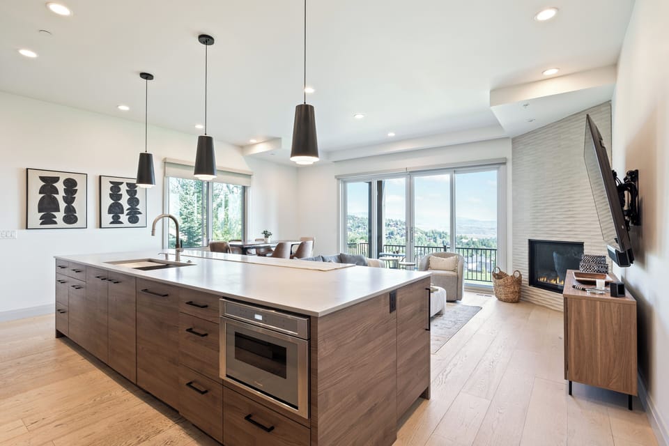Modern kitchen showcasing an expansive island with sink, generous counter space, and bar seating. Designed for cooking, entertaining, and connecting with the open living area.