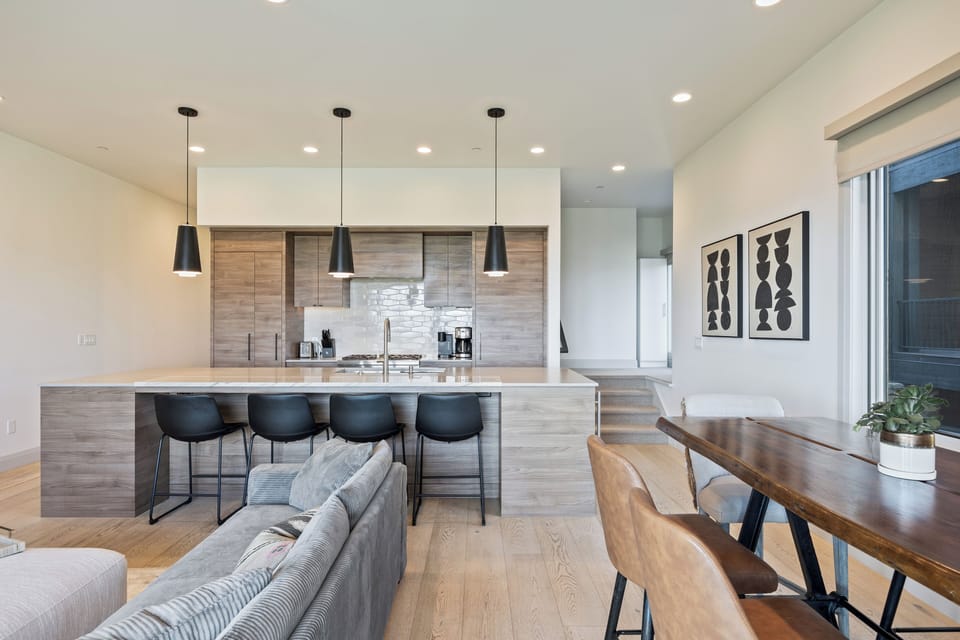 Contemporary kitchen with a sleek island, pendant lighting, and bar seating perfect for casual meals and entertaining.