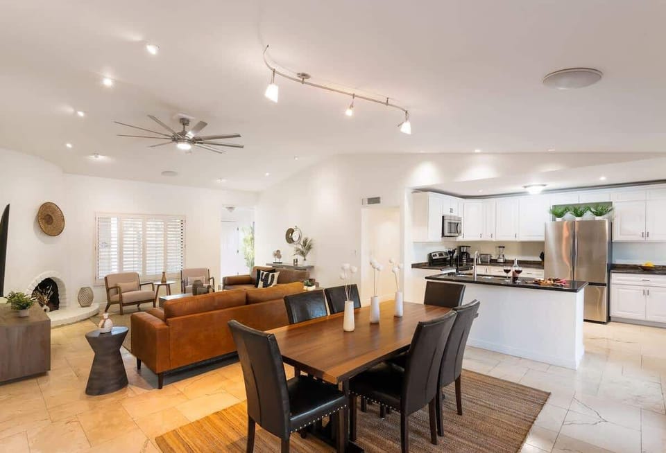 The dining room table is perfect for six people with outdoor patio views.