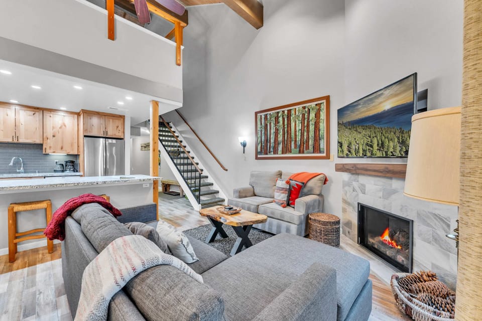 Living Room: 2 couches, 55” Smart TV, gas fireplace, access to balcony 
