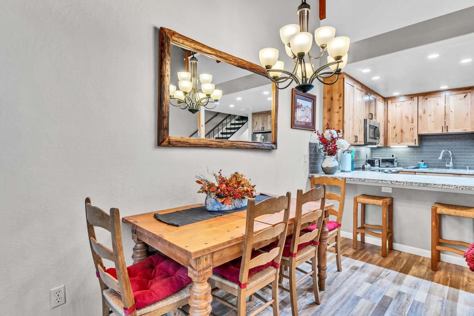 Dining Room: 4-person dining table, situated next to sliding glass doors for balcony
