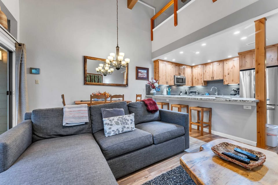 Living Room: 2 couches, 55” Smart TV, gas fireplace, access to balcony 
