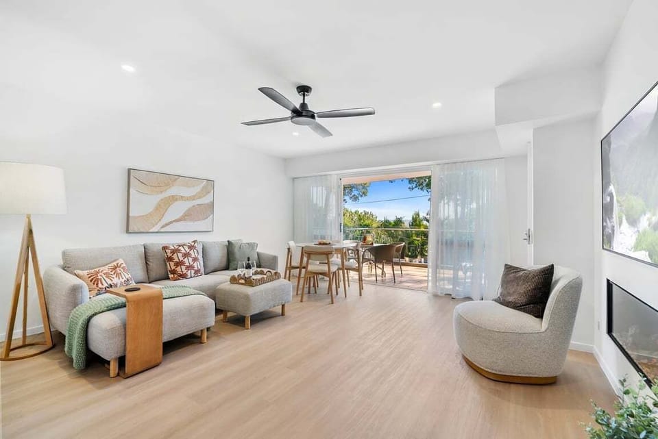 Living area includes fireplace and views out to balcony