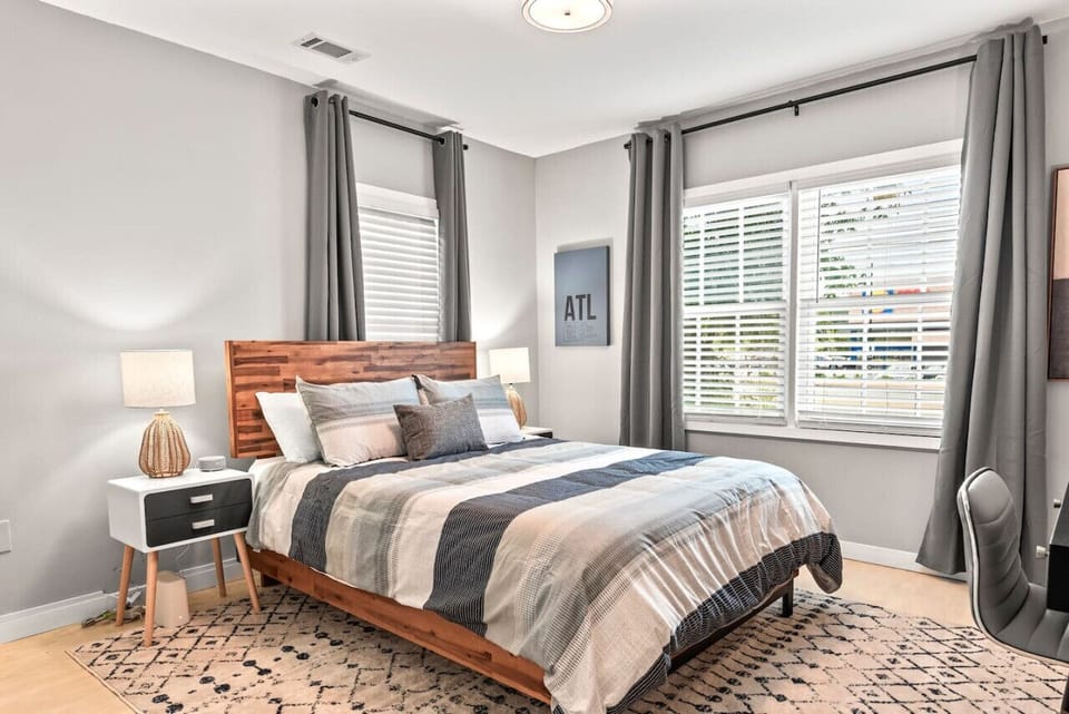 Rest easy in this cozy bedroom featuring a super comfortable queen bed, soft linens, and stylish décor—your perfect retreat after a day of exploring Atlanta.