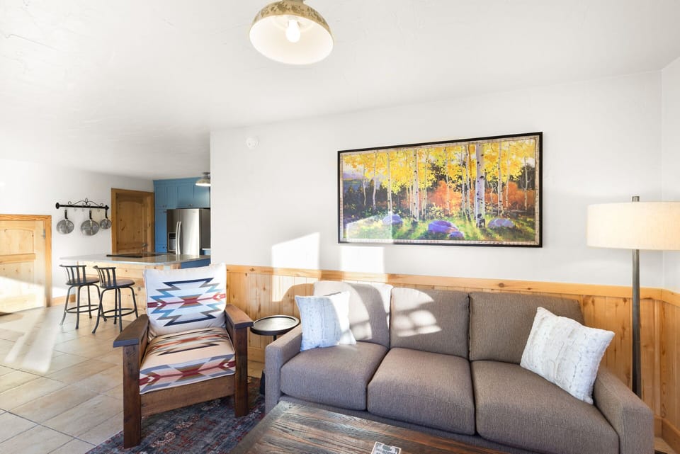 The main living area has a Smart TV, a wood-burning stove, and opens into the kitchen and dining area.