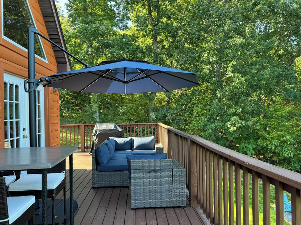 Outdoor deck accessed from main level.  Cocktail table seating, sectional and umbrella. 
