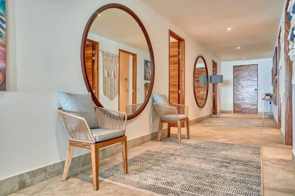 An inviting hallway welcomes you into the condo, adorned with beautiful artwork that adds a touch of elegance and charm