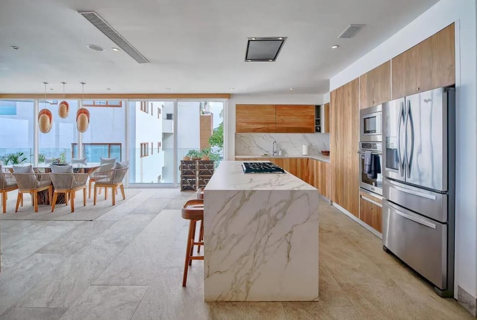 The gourmet kitchen is equipped with a full-size fridge, stove, oven and microwave