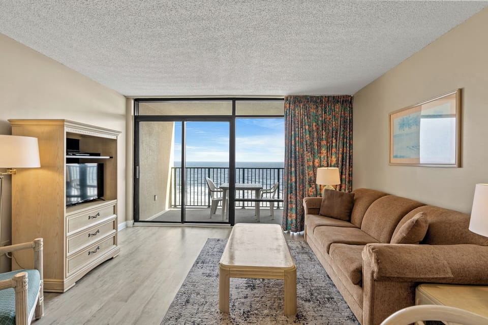 The private balcony off the living room invites you to step outdoors.