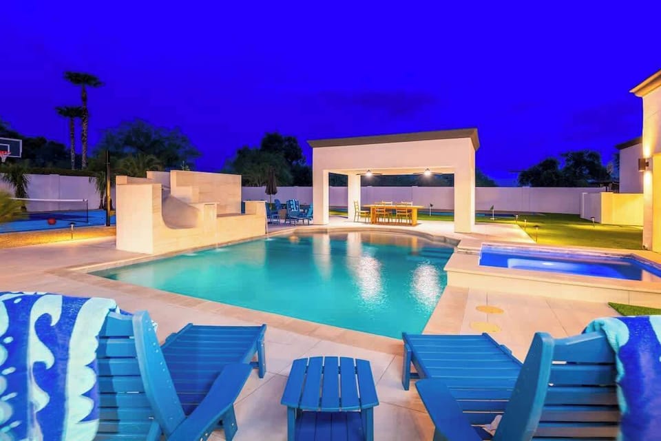 Modern pool oasis at twilight, featuring your private pool with lounge seating, covered pavilion, and spacious backyard designed for relaxation and entertaining under the stars.