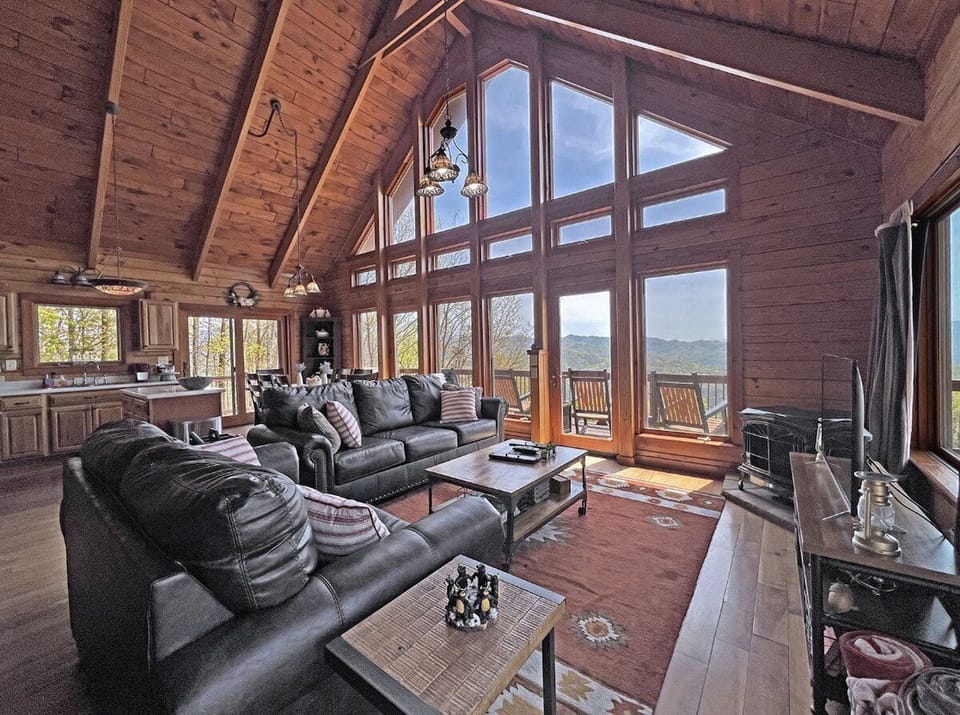 Mountain Views
Open living area featuring vaulted wood ceilings, large picture windows, and expansive mountain views. The wall of glass brings the Smoky Mountains directly into the main gathering space.