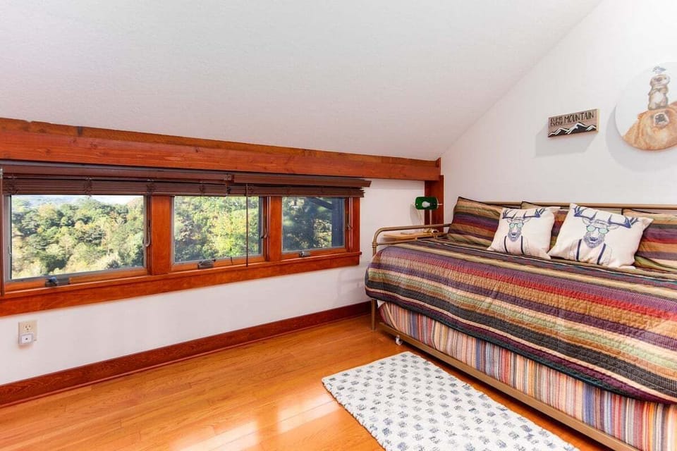 Loft space featuring twin-over-twin trundle beds and natural light at Lookout Lodge near Lake Fontana.
