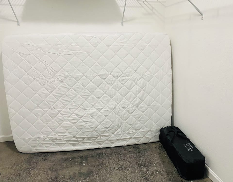 Full Mattress and Portable Crib in Master Closet