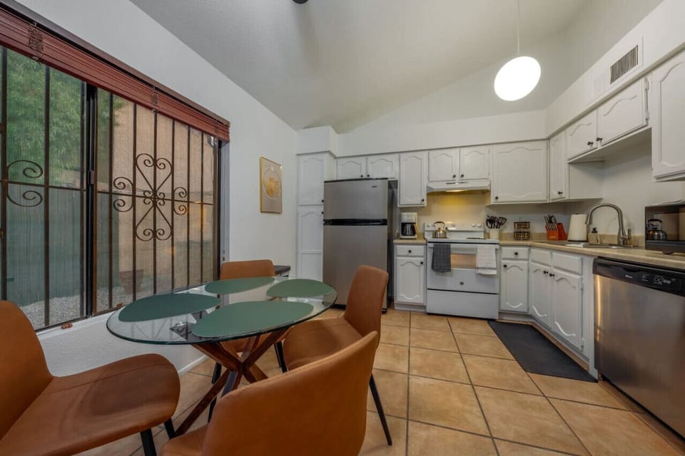 Eat-in kitchen with seating for four and views of the back patio