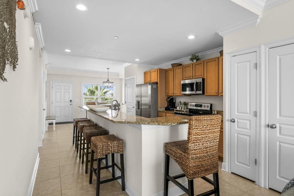 Your spacious kitchen features granite countertops, full appliances, and a breakfast bar where you'll start each morning with coffee.