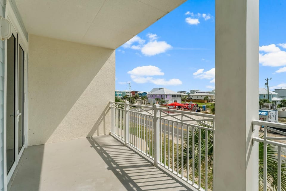 Step onto your private balcony and soak in the coastal neighborhood views with colorful beach houses dotting the landscape.
