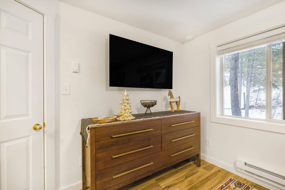 bedroom #1 on main level w/ queen bed and small ensuite bathroom