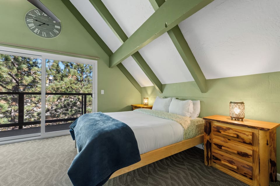 The third floor queen bedroom features a private patio, workspace and vaulted ceilings. 